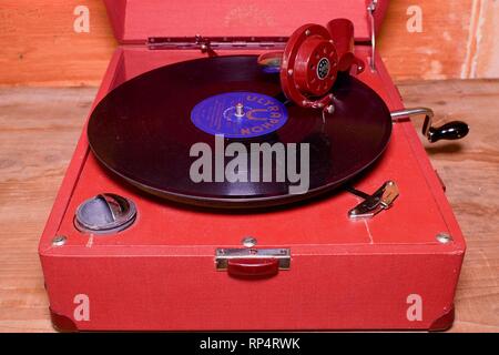 Image shows vintage gramophone famous Czech brand Supraphone. The red wind-up gramophone and vinyl record brand Ultraphon .  Stock Photo