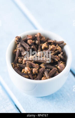 Carnation, dried clove spice in bowl. Stock Photo