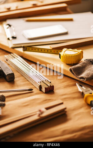 Various tools on carpentry woodwork workshop desk, selective focus with shallow depth of field Stock Photo