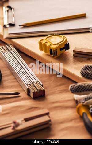 Various tools on carpentry woodwork workshop desk, selective focus with shallow depth of field Stock Photo