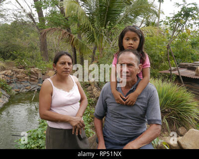 El Salvador  JDS projects in Jujutla.  Family of Alvaro Tejada (60), his wife Agripina Castillo (34) with their daughter Fatima Tejada (6), in village of Los Vasquez, Jujutla. Family portrait. Stock Photo