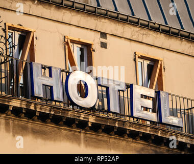 Hotel sign on the facade of old hausmannian building in central Paris - romantic French city warm sunset colors Stock Photo
