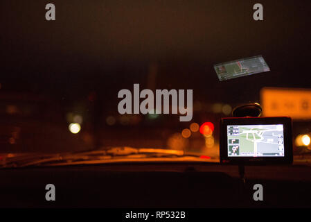 Navigation system in car at night GPS for click on at the windshield Stock Photo
