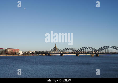 Iron railway bridge over the river Daugava on a sunny winter day - Riga, Latvia Stock Photo