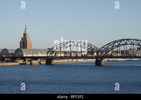 Iron railway bridge over the river Daugava on a sunny winter day - Riga, Latvia Stock Photo