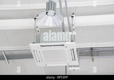 White air conditioner hanging on white wall. Air cool Stock Photo - Alamy