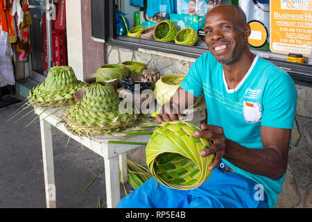 Local man making straw hats and bowls, Upper Bay Street, Kingston, Saint Vincent and the Grenadines, Lesser Antilles, Caribbean Stock Photo