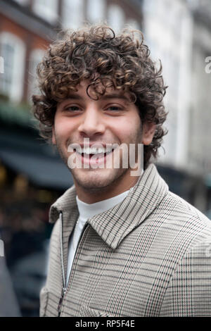 LONDON, UK - FEBRUARY 15, 2019: London Fashion week. Eyal Booker - curly-haired model who has worked with brands such as Adidas and Bang+Strike. Stock Photo