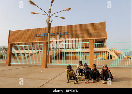 NIGER Niamey, soccer stadium PALAIS DU 29 JUILLET, children with self made plastic  tin shed toy cars Stock Photo