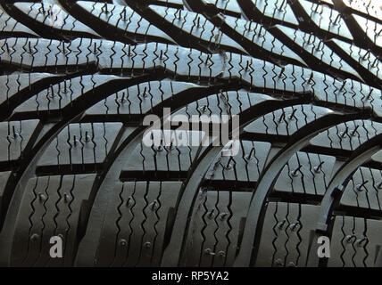 Tread pattern blocks and grooves of new vehicle tire macro shot Stock Photo