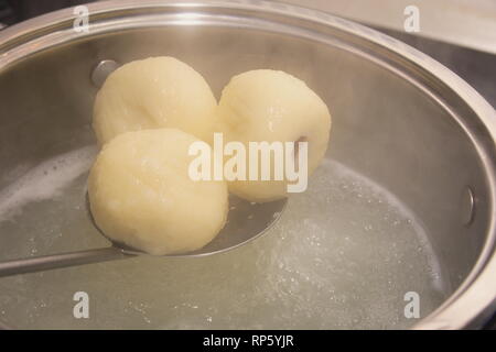 Cooking Plum Dumplings in Hot Water Closeup Stock Photo