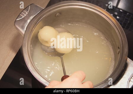 Cooking Plum Dumplings in Hot Water Closeup Stock Photo