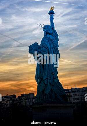 Replica of the Liberty Statue against the sunset in Paris Stock Photo