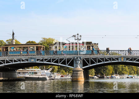 Blue tram / old streetcar passing a bridge from Östermalm to Djurgarden in Stockholm during summer (Stockholm, Sweden, Europe) Stock Photo
