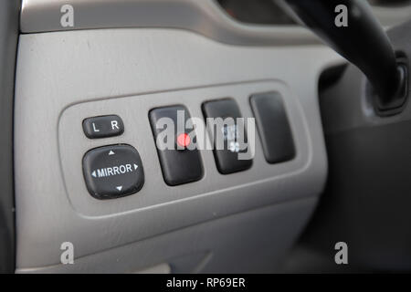 vehicle side view mirror controls and security system indicator light Stock Photo