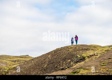 Hveragerdi, Iceland - September 18, 2018: Trail in Reykjadalur during day in south golden circle landscape and two people women standing on top of mou Stock Photo