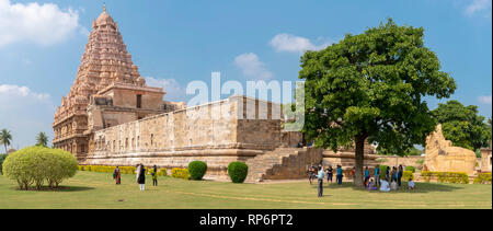 A 2 picture stitch panoramic view of the Brihadisvara Temple at Gangaikonda Cholapuram with tourists visiting on a sunny day with blue sky. Stock Photo