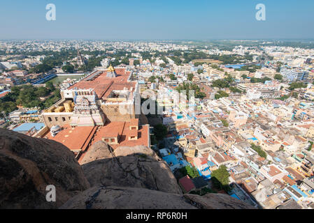 A cityscape view over Tiruchirappalli or Trichy in India taken from the Rock Fort Temple on a sunny day with blue sky. Stock Photo