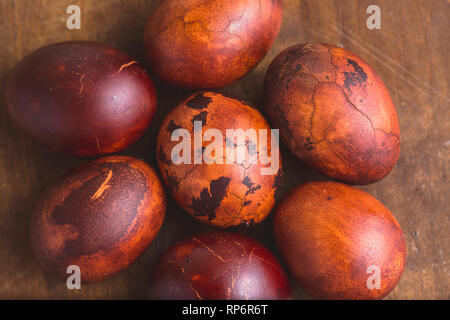 Easter eggs on wooden background. Painted brown with spots and cracks. Selective focus macro shot with shallow DOF Stock Photo