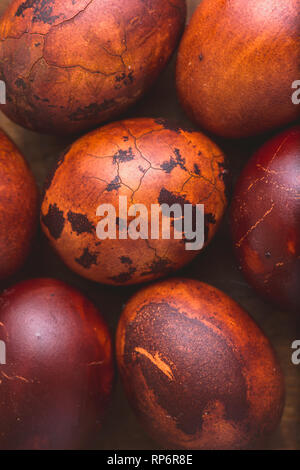 Easter eggs on wooden background. Painted brown with spots and cracks. Selective focus macro shot with shallow DOF Stock Photo