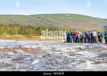 Haukadalur Valley, Iceland - September 19, 2018: Geyser landscape with people tourists waiting in south Icelandic country by Strokkur Geysir Hot Sprin Stock Photo