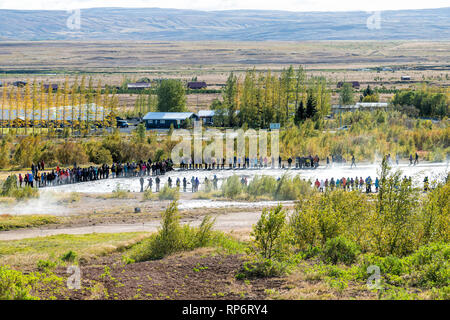 Haukadalur Valley, Iceland - September 19, 2018: Geyser high angle landscape with people tourists waiting by Strokkur Geysir eruption on Golden Circle Stock Photo