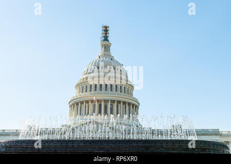 US Capitol dome and American waving flag in Washington DC with blue sky ...