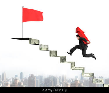 Businessman carrying red arrow running on money stairs to red flag on ...