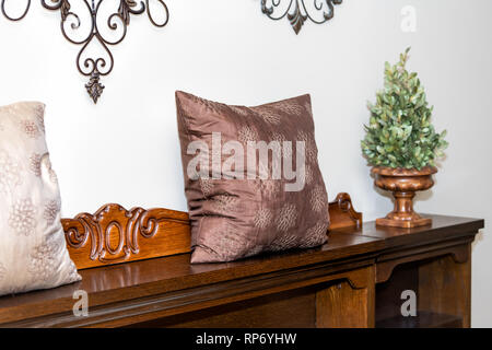 Closeup of antique vintage retro wooden bed frame in luxury boutique hotel with old-fashioned decorations pillows in home house brown color Stock Photo