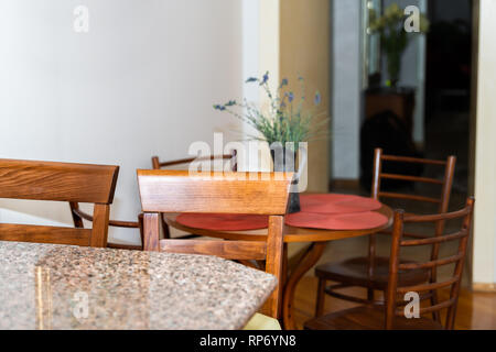 Wooden brown kitchen counter and granite countertop bar with two chairs in small apartment stool interior design with table and corridor hall Stock Photo