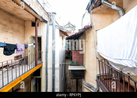 Typical courtyard for hanging clothes in summer drying on rack clothesline line in Ukraine by old vintage Lviv Ukrainian apartment buildings Stock Photo