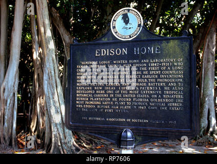 Amid the aerial roots of old banyan trees, a vintage sign describes the 1880s winter home and laboratory of renowned inventor Thomas Alva Edison in Fort Myers, Florida, USA. Those structures are now part of a sprawling historical museum where tourists can view and learn about some of Edison's most famous inventions, including the incandescent light bulb, phonograph, motion picture camera and storage battery. Edison's friend, automaker Henry Ford, purchased an adjoining home in 1916 and today it is part of the 21-acre Edison and Ford Winter Estates that include vast botanical gardens. Stock Photo
