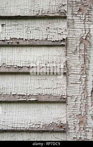 Detail of weathered white paint on an old clapboard wall Stock Photo