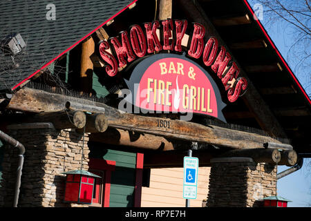 A logo sign outside of a Smokey Bones Bar and Fire Grill restaurant location in Fredericksburg, Virginia on February 19, 2019. Stock Photo