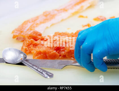 chef slicing raw fresh salmon, Chef preparing a fresh salmon on a cutting board Stock Photo