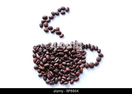 Roasted coffee beans scattered into a shape of a cup with rising steam. Isolated on white background. Stock Photo