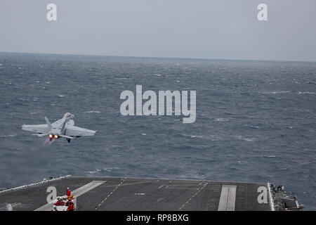 190219-N-MM912-2015 ATLANTIC OCEAN (Feb. 19, 2019) F/A-18F Super Hornets assigned to the 'Jolly Rogers' of Strike Fighter Squadron (VFA) 103 launches from the flight deck of the Nimitz-class aircraft carrier USS Abraham Lincoln (CVN 72). Abraham Lincoln is underway conducting composite training unit exercise (COMPTUEX) with Carrier Strike Group (CSG) 12. The components of CSG 12 embody a team-of-teams concept, combining advanced surface, air and systems assets to create and sustain operational capability. This enables them to prepare for and conduct global operations, have effective and lastin Stock Photo