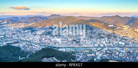 Business concept, modern cityscape of nagasaki dusk from mount inasa, the new top 3 nightview of the world, aerial view, copy space Stock Photo