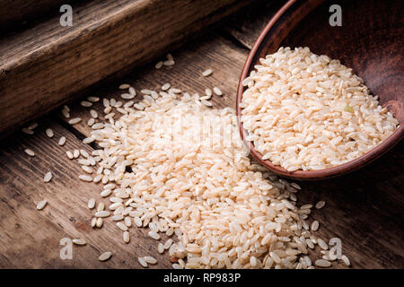 Raw grain white rice in a ceramic bowl.Healthy food. Stock Photo
