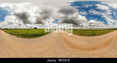 360 degree panoramic view of full seamless spherical panorama 360 by 180 degrees angle view on gravel road among fields in sunny summer day with awesome clouds in equirectangular