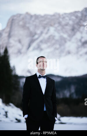 Groom posing in the mountains Stock Photo
