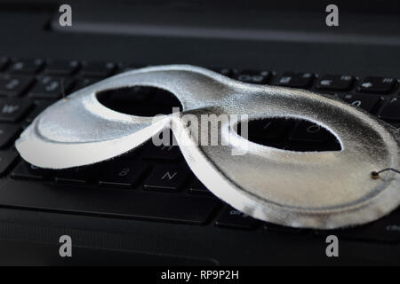 Mask on laptop keyboard - Concept of privacy, security and anonymity of computer users Stock Photo