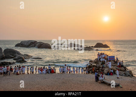 HDR image of crowds of local Indian people like to go to the beach at sunset to watch the sun go down on the beach at Sunset View Point in Kanyakumari. Stock Photo