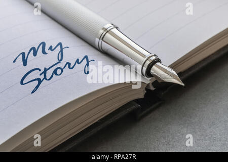 Fountain pen and text My Story written on an open notebook Stock Photo