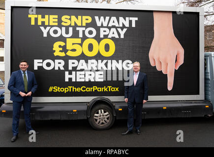 Edinburgh, Scotland, UK. 21st Feb, 2019. Jackson Carlaw MSP and Miles Briggs MSP unveil an Ad Van at an Edinburgh care home today before it travels across the central belt of Scotland to workplaces that are set to be hit by the proposed Car Park Tax which is to be voted through the Scottish Parliament by the SNP and Green parties. Pictured ; Miles Briggs MSP (L) and Jackson Carlaw MSP Credit: Iain Masterton/Alamy Live News Stock Photo