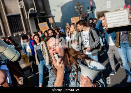 A woman is seen shouting slogans on a megaphone during the demonstration. For the seventh consecutive time Belgian students skipped school to demonstrate for better climate policy. This time the demonstration counts with the participation and support of the teenage Swedish activist Greta Thunberg. The teenage Swedish activist went on a school strike in August 2018, protesting each week outside her country’s parliament to draw attention to climate change. Stock Photo