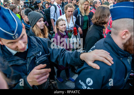 February 21, 2019 - Brussels, North of Brabant, Belgium - The teenage Swedish activist Greta Thunberg is seen surrounded by the Belgian police during the demonstration.For the seventh consecutive time Belgian students skipped school to demonstrate for better climate policy. This time the demonstration counts with the participation and support of the teenage Swedish activist Greta Thunberg. The teenage Swedish activist went on a school strike in August 2018, protesting each week outside her country's parliament to draw attention to climate change. (Credit Image: © Ana Fernandez/SOPA Images v Stock Photo