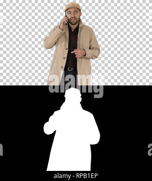 On Alpha Matte. Medium shot. Young fashionable businessman talking on mobile phone, Alpha Channel Professional shot in 4K resolution. 006. You can use Stock Photo