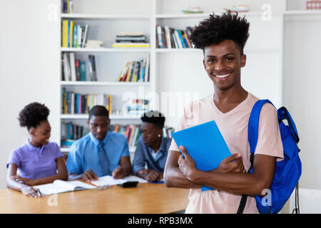 African american young adult student looking at camera with class at school Stock Photo