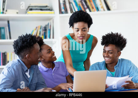 African american female teacher with students at university Stock Photo